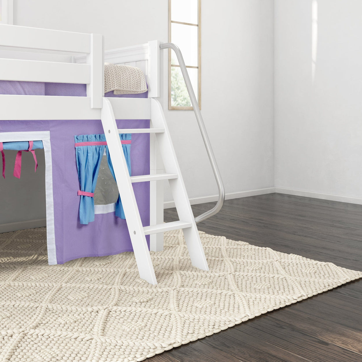 Loft bed with purple tent and slide on dark wood floor in bright room.