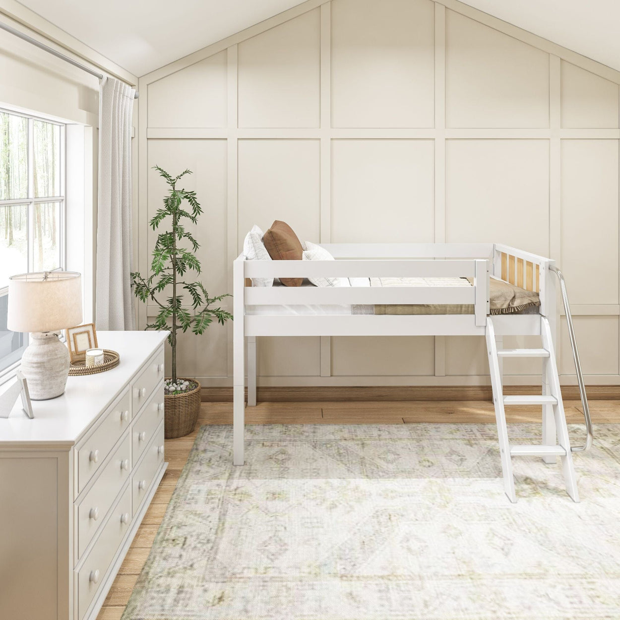 Modern kids' room with loft bed, dresser, and decor elements for a stylish and functional space.