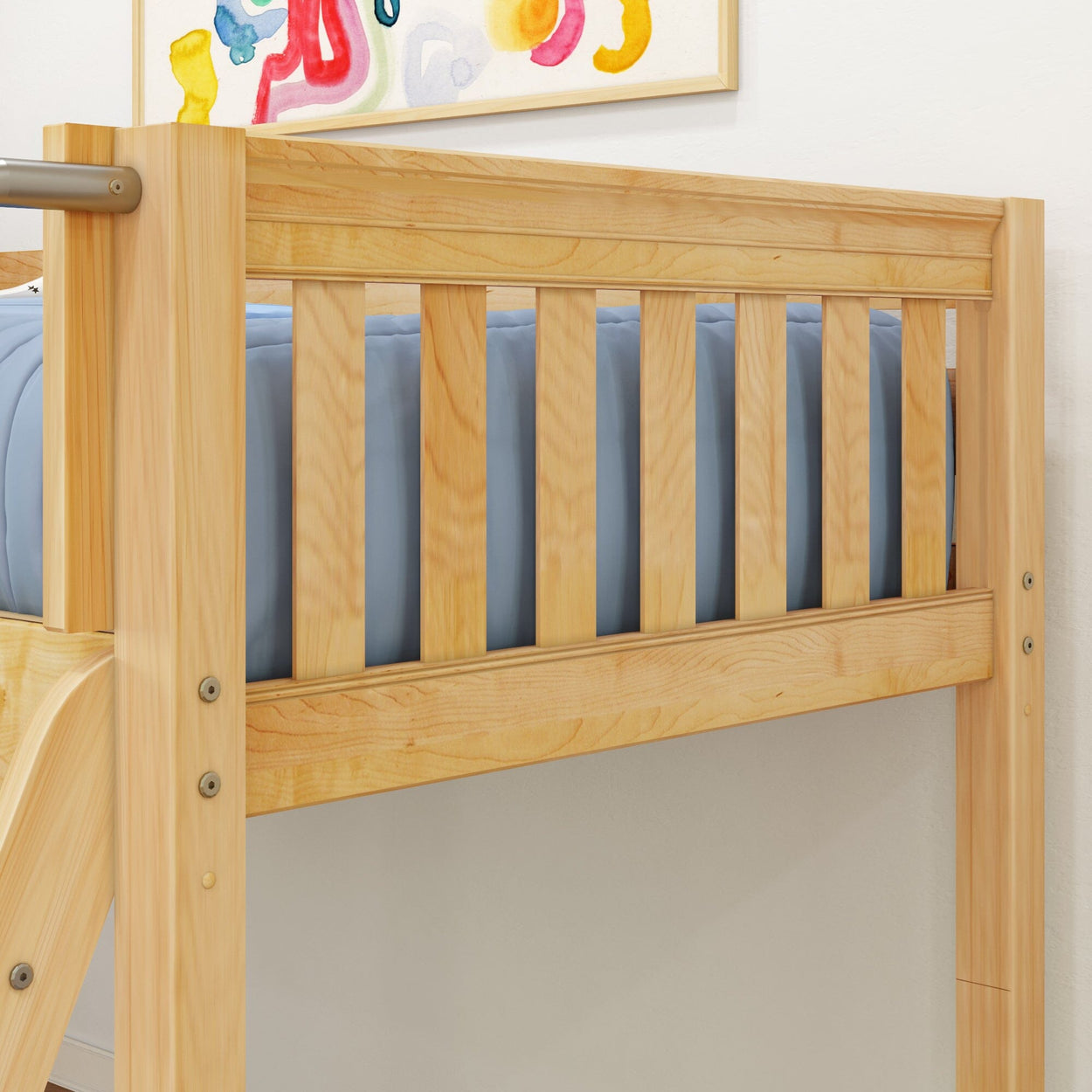 Wooden loft bed with blue mattress and colorful wall art.