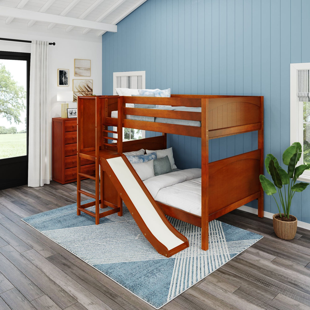 Children's wooden bunk bed with slide in a stylish bedroom featuring blue paneled walls and modern decor.