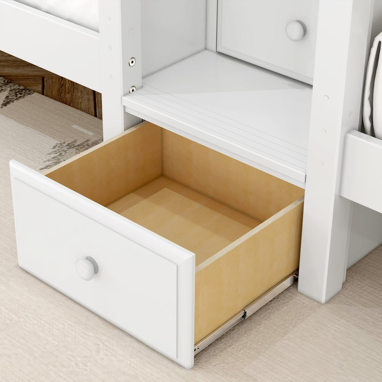 White wooden drawer opened under a bed showing storage space for organizing bedroom items.