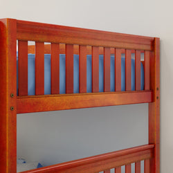 Red wooden bunk bed frame with blue mattress in a modern minimalist bedroom.