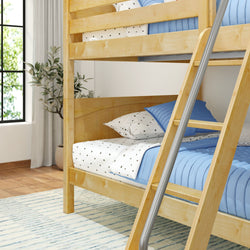 Wooden bunk bed with blue and white bedding in a cozy bedroom setup with natural light and plant decor.