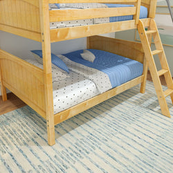 Wooden bunk bed with blue and white bedding and ladder in a cozy bedroom setting.