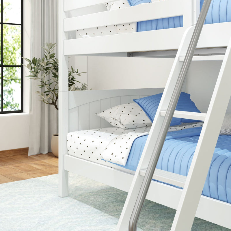 White wooden bunk bed with ladder, blue quilted bedding and star-print sheets in a bright modern kids bedroom with window and potted plant
