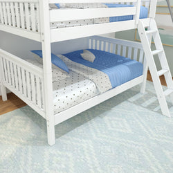 White wooden bunk bed with blue and white bedding in a bright, cozy bedroom featuring a soft area rug.