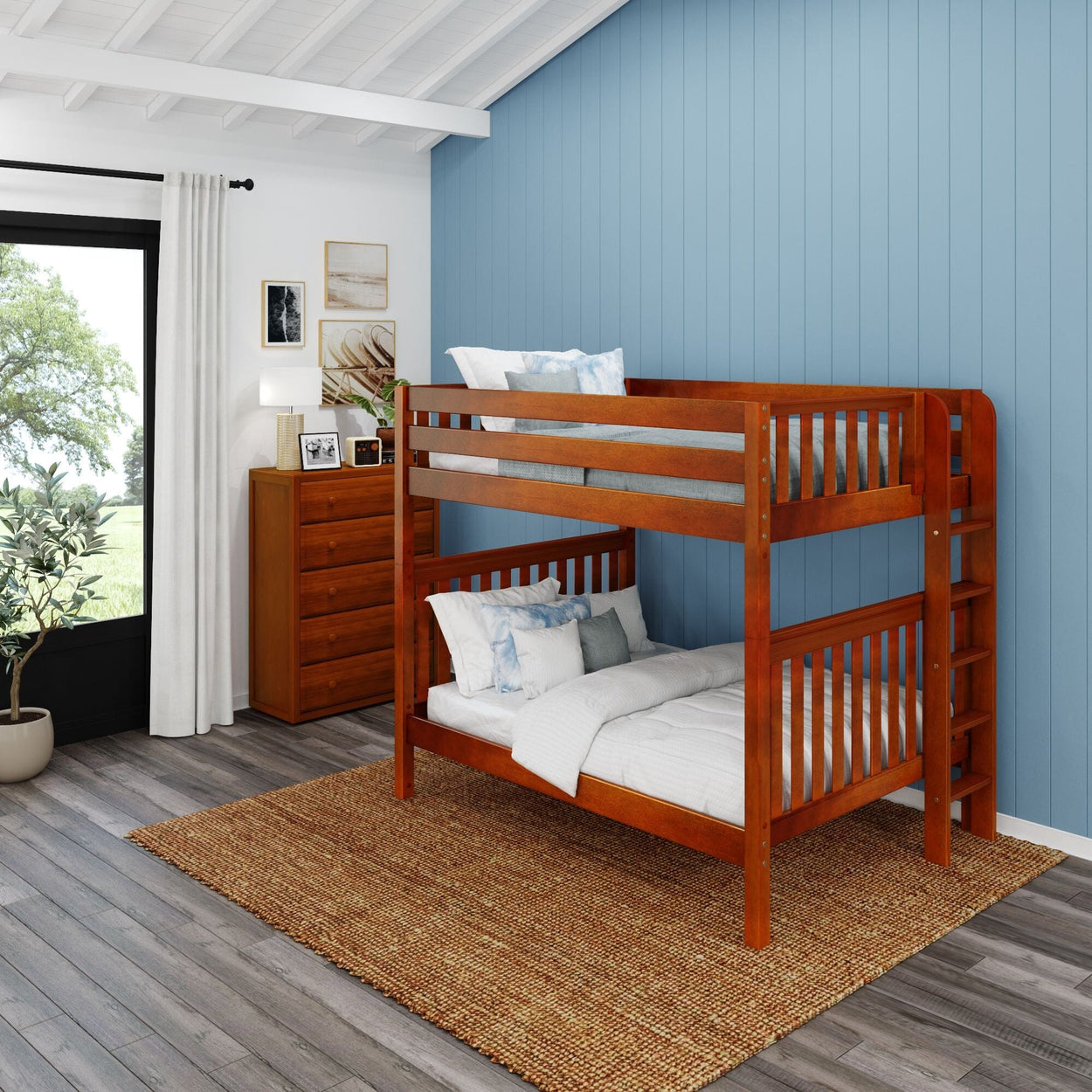 Wooden bunk bed in modern bedroom with blue accent wall and natural light.