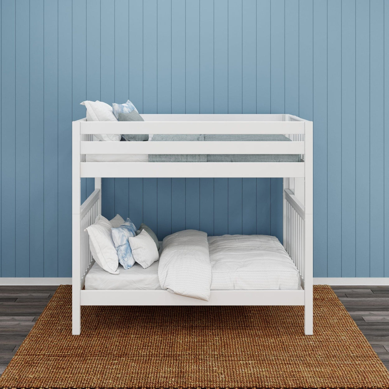 White wooden bunk bed with blue and white bedding against a blue paneled wall in a modern bedroom.