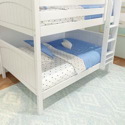 White wooden bunk bed with blue bedding and star-patterned sheets in a cozy children's room.