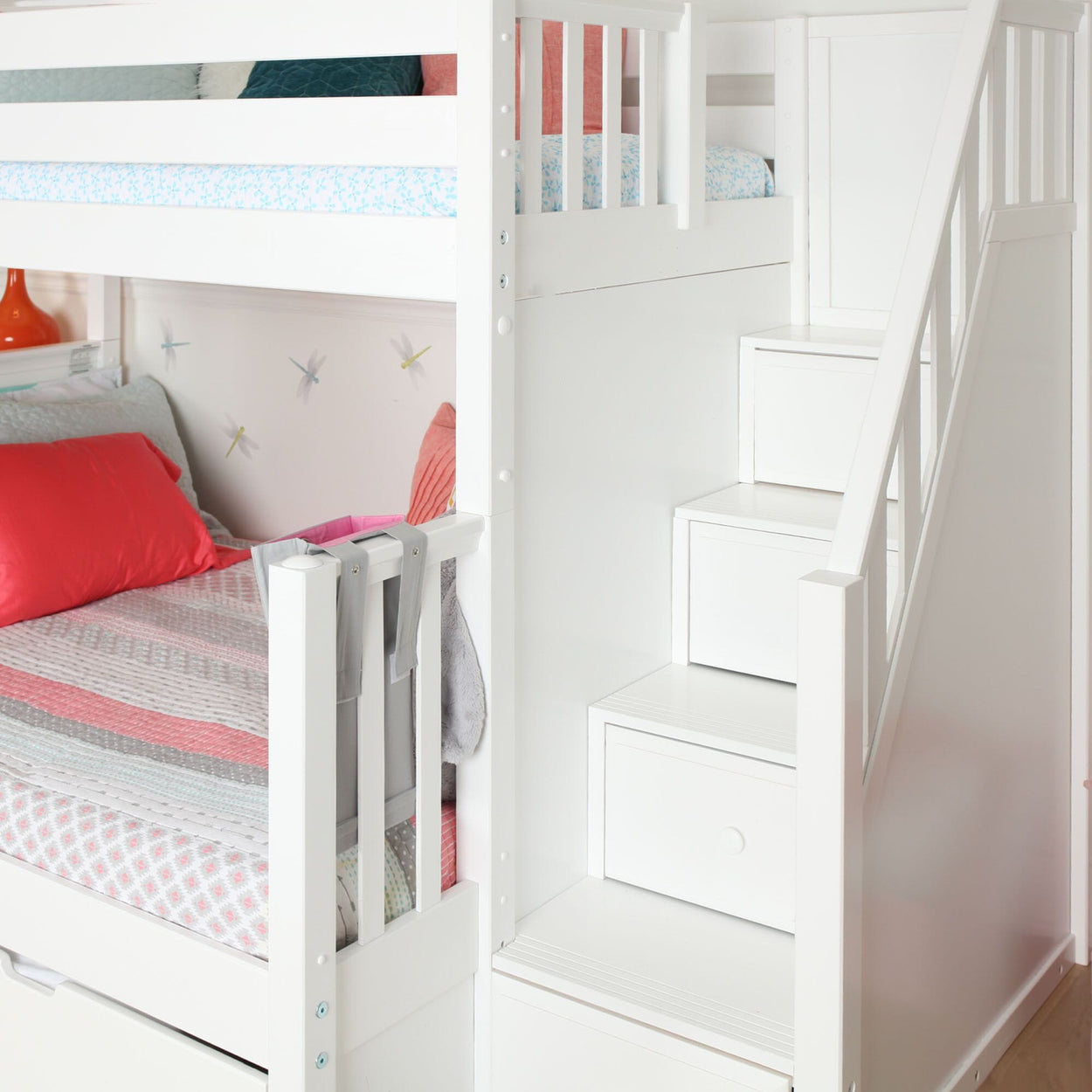 White bunk bed with built-in storage stairs and colorful bedding in a child's bedroom.