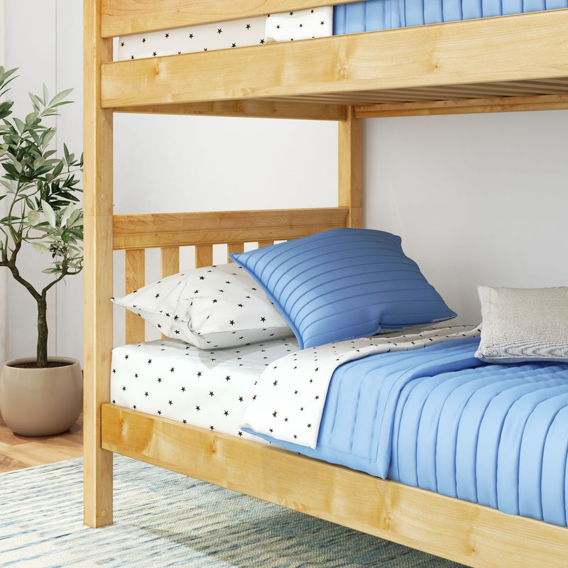 Natural wood bunk bed with blue quilt and star-print sheets in a modern kids' bedroom with potted plant and light rug