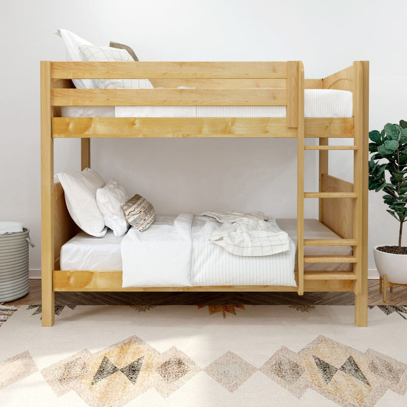 Natural pine wooden bunk bed with white bedding and ladder in a modern kids bedroom featuring a boho rug and potted plant