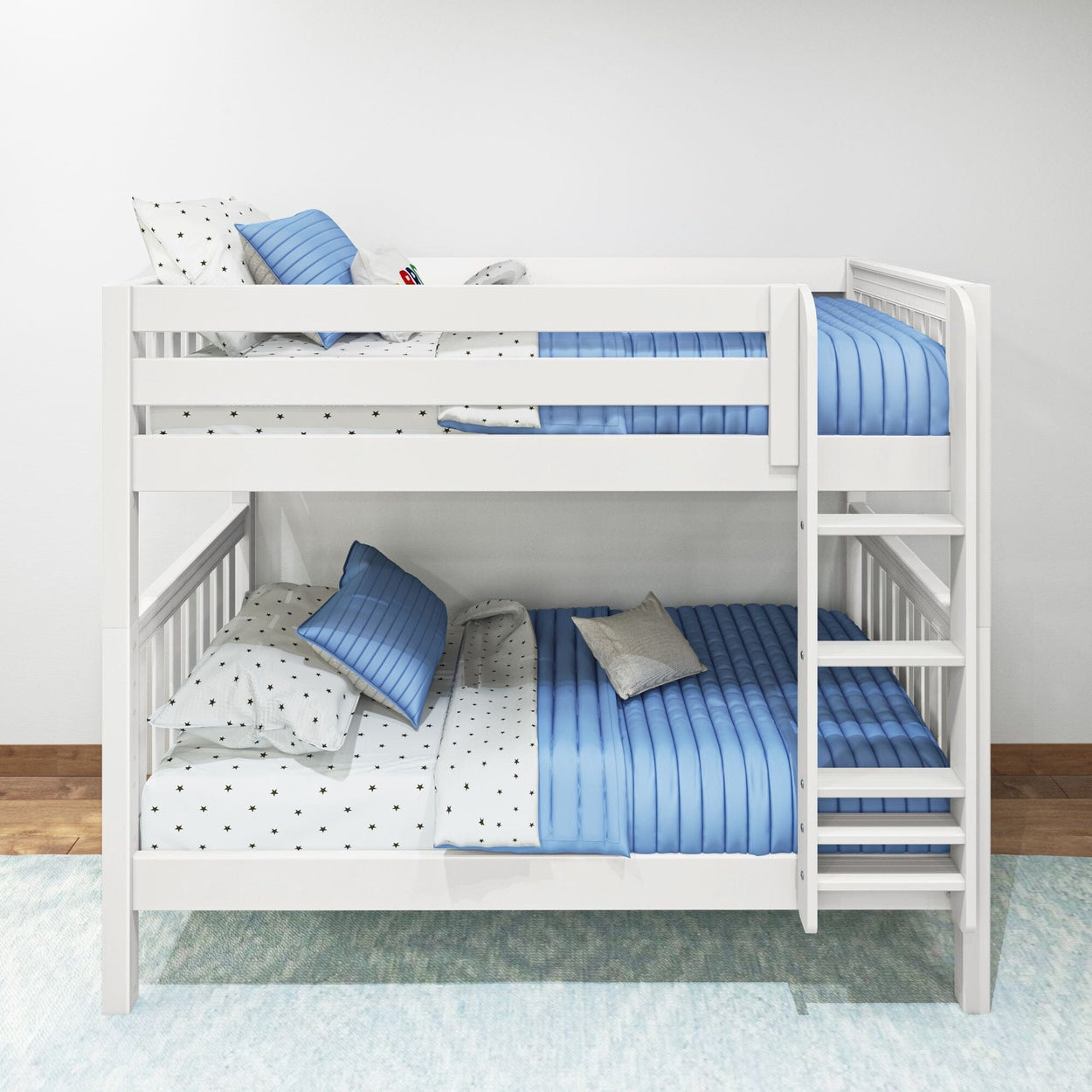 White wooden bunk bed with blue striped bedding and star-patterned sheets against a white wall.