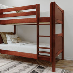Wooden bunk bed with pillows and blankets on top and bottom bunks in a modern bedroom setting.