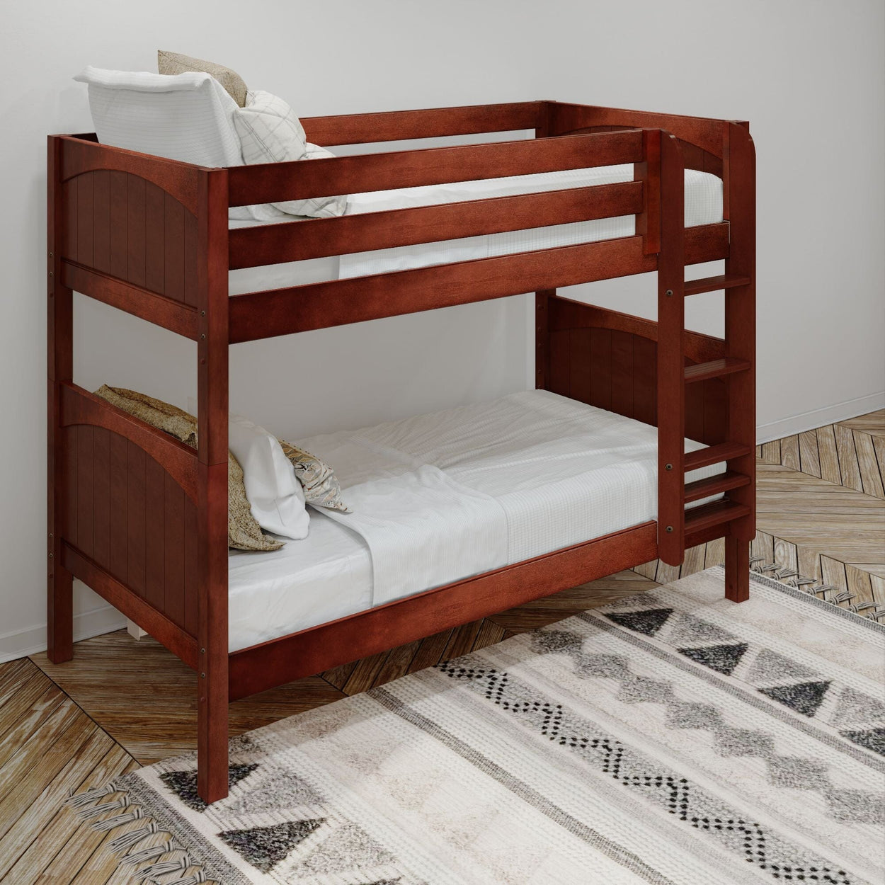 Wooden bunk bed with white bedding in modern bedroom with patterned rug.