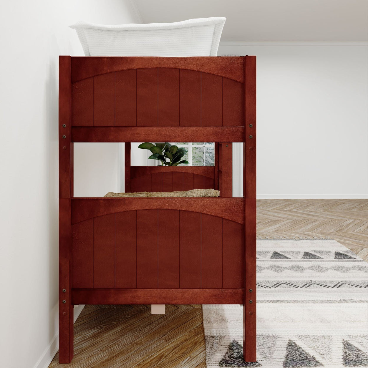 Red wooden bunk bed with white bedding in a modern minimalistic room featuring hardwood floors and geometric patterned rug.