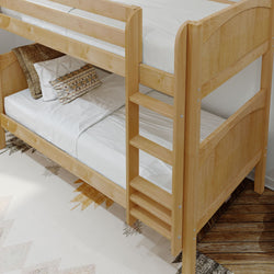Wooden bunk bed with ladder and white linens in a cozy bedroom setting.