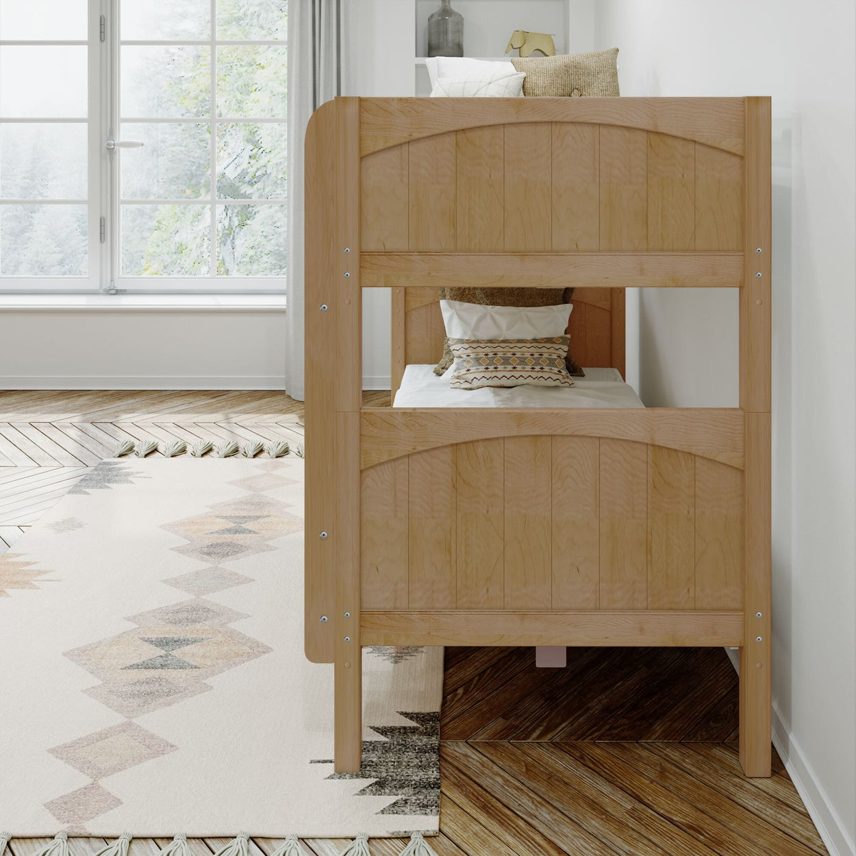 Wooden bunk bed with decorative pillows in a bright, modern bedroom featuring a large window and patterned rug.