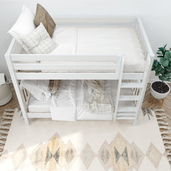 White wooden bunk bed with cozy bedding and pillows in a minimalist bedroom decor.