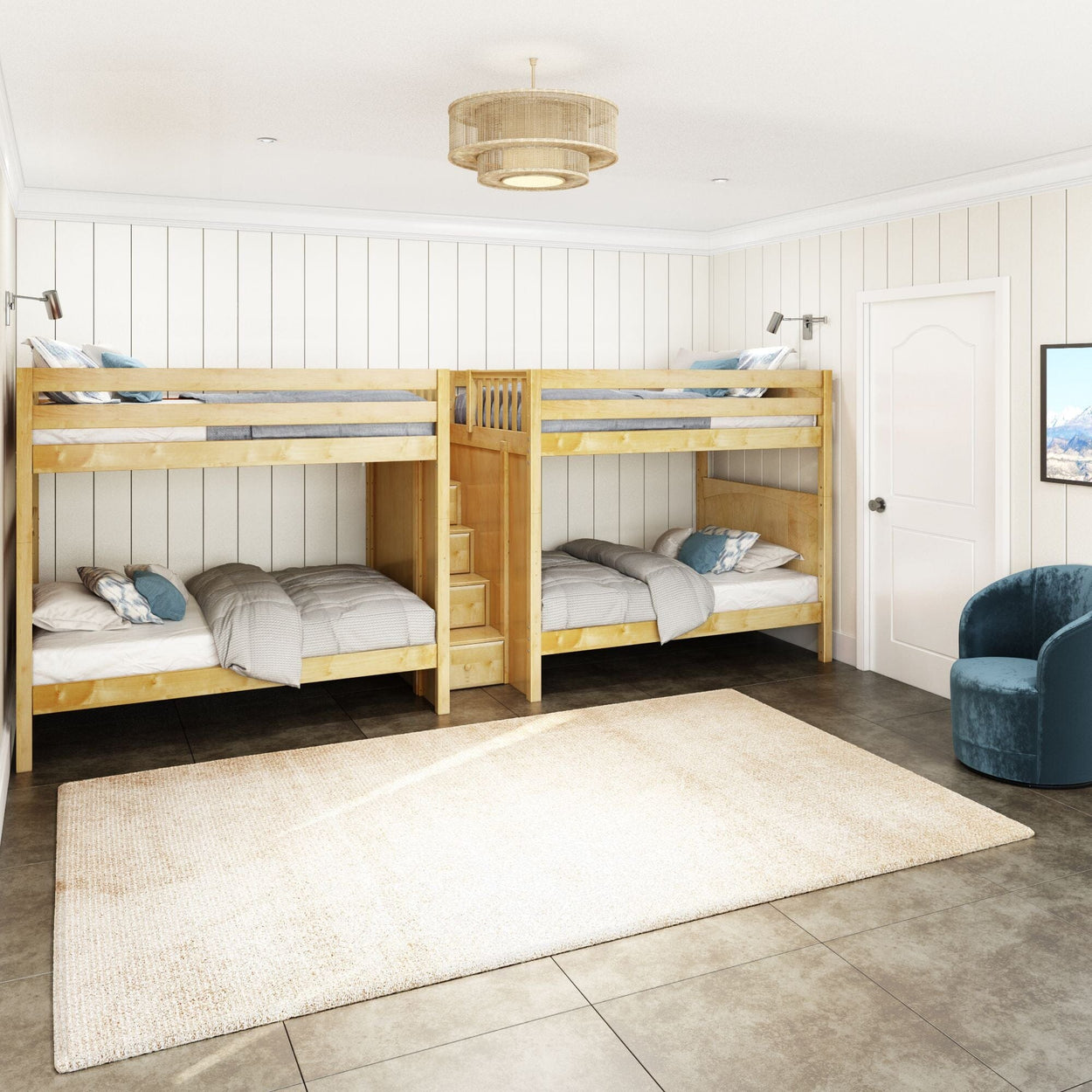 Four wooden bunk beds in a modern bedroom with white paneled walls, large beige rug, and a blue velvet chair.