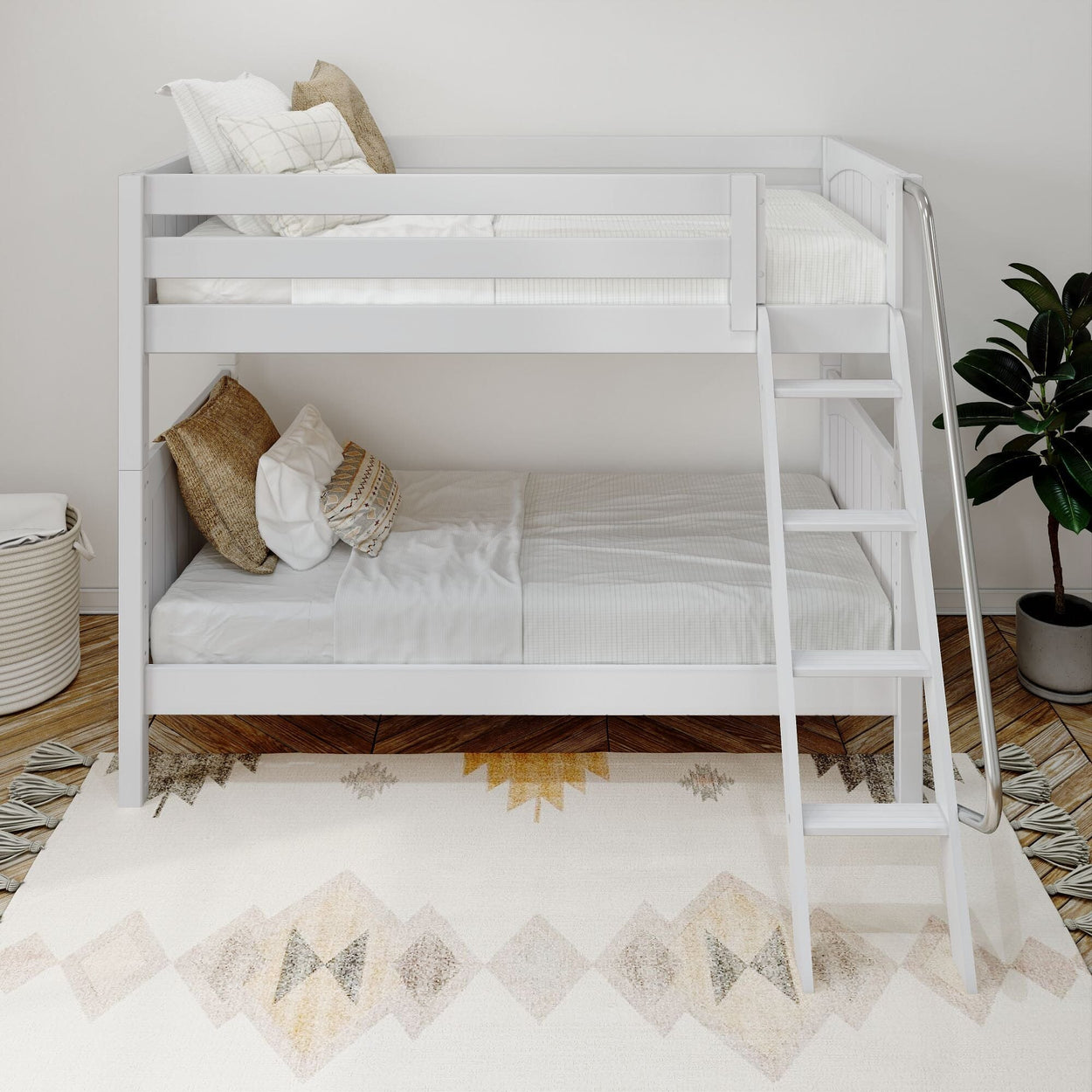 Modern white bunk bed in a bright bedroom with cozy pillows and a geometric rug.