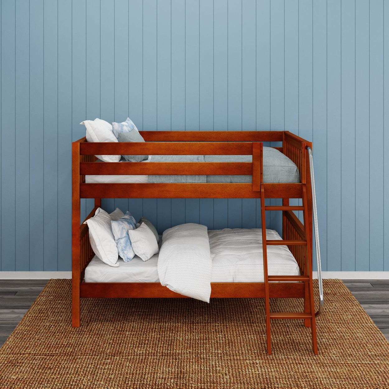 Wooden bunk bed with comfortable bedding in a kids’ bedroom with blue paneled walls.