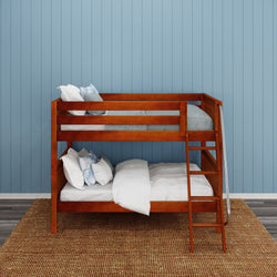 Wooden bunk bed with comfortable bedding in a kids’ bedroom with blue paneled walls.