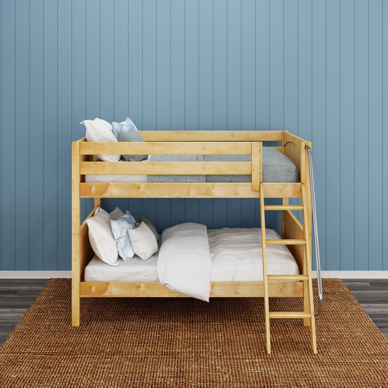 Wooden bunk bed with ladder in a modern bedroom with blue accent wall and a woven area rug.