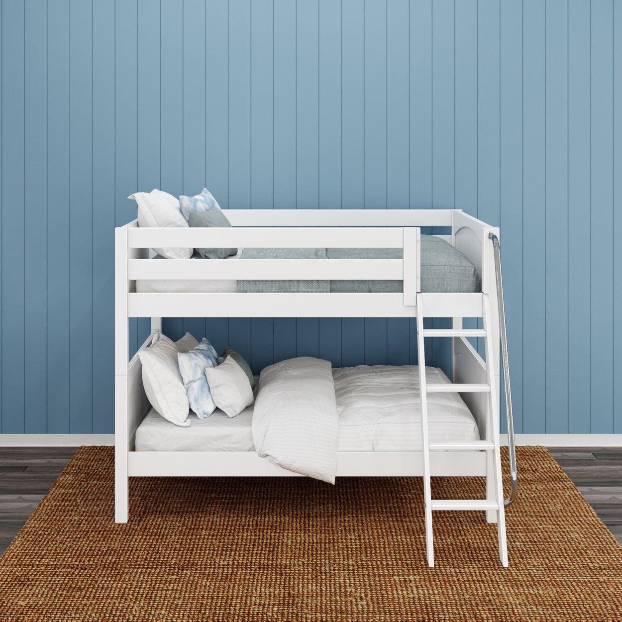 White bunk bed against a blue panel wall with cozy bedding and a ladder.