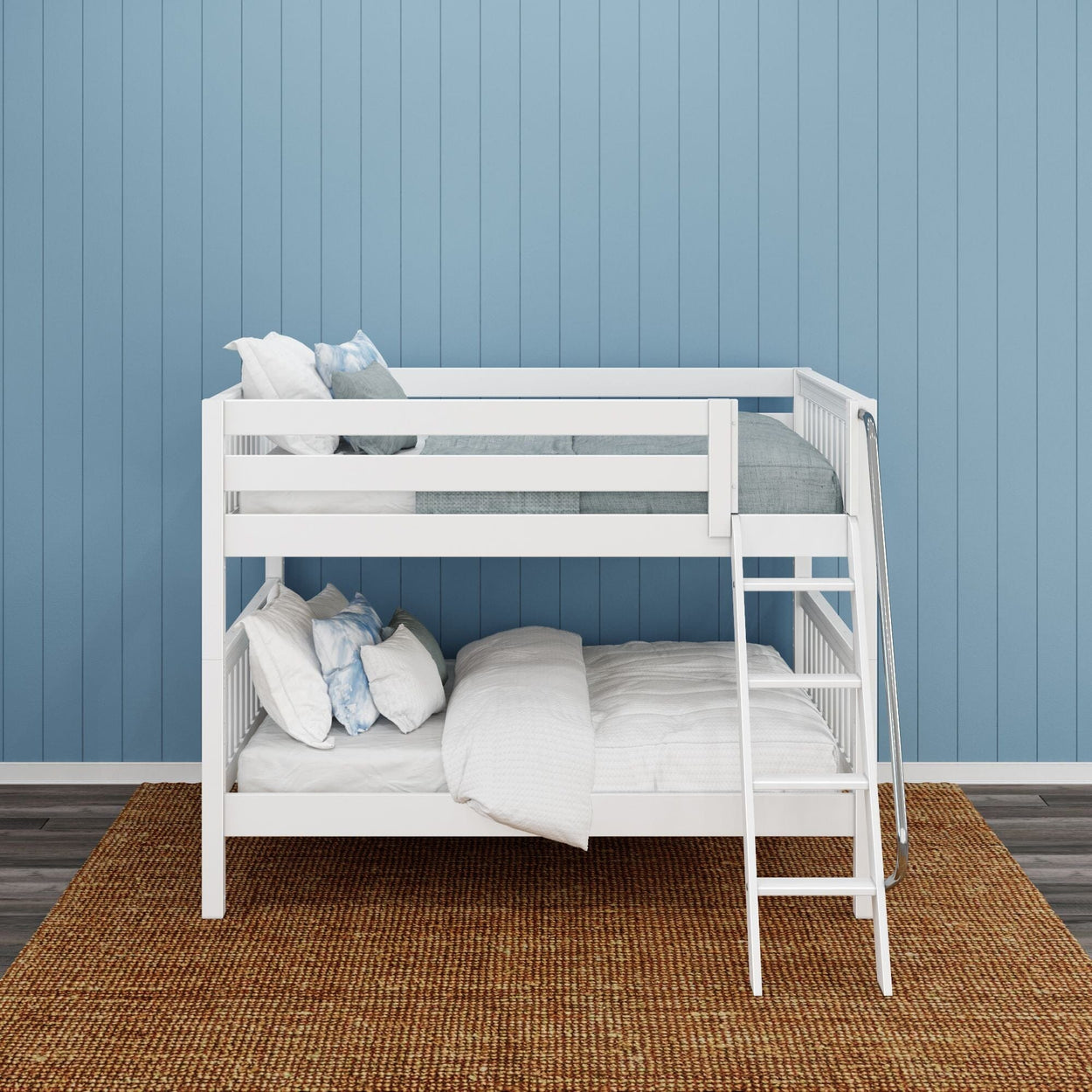 White wooden bunk bed with bedding in a room with blue walls and a woven rug.