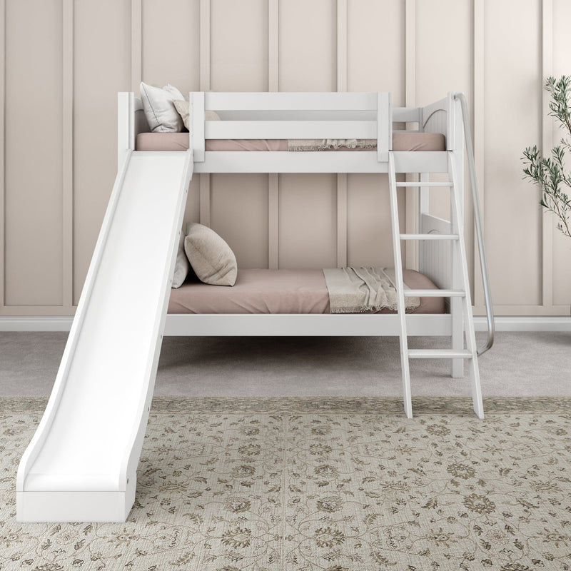 White wooden bunk bed with slide and ladder in neutral kids' bedroom, blush bedding, beige paneled wall, patterned rug