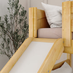 Wooden bunk bed with slide and white cushions in a modern bedroom setting.