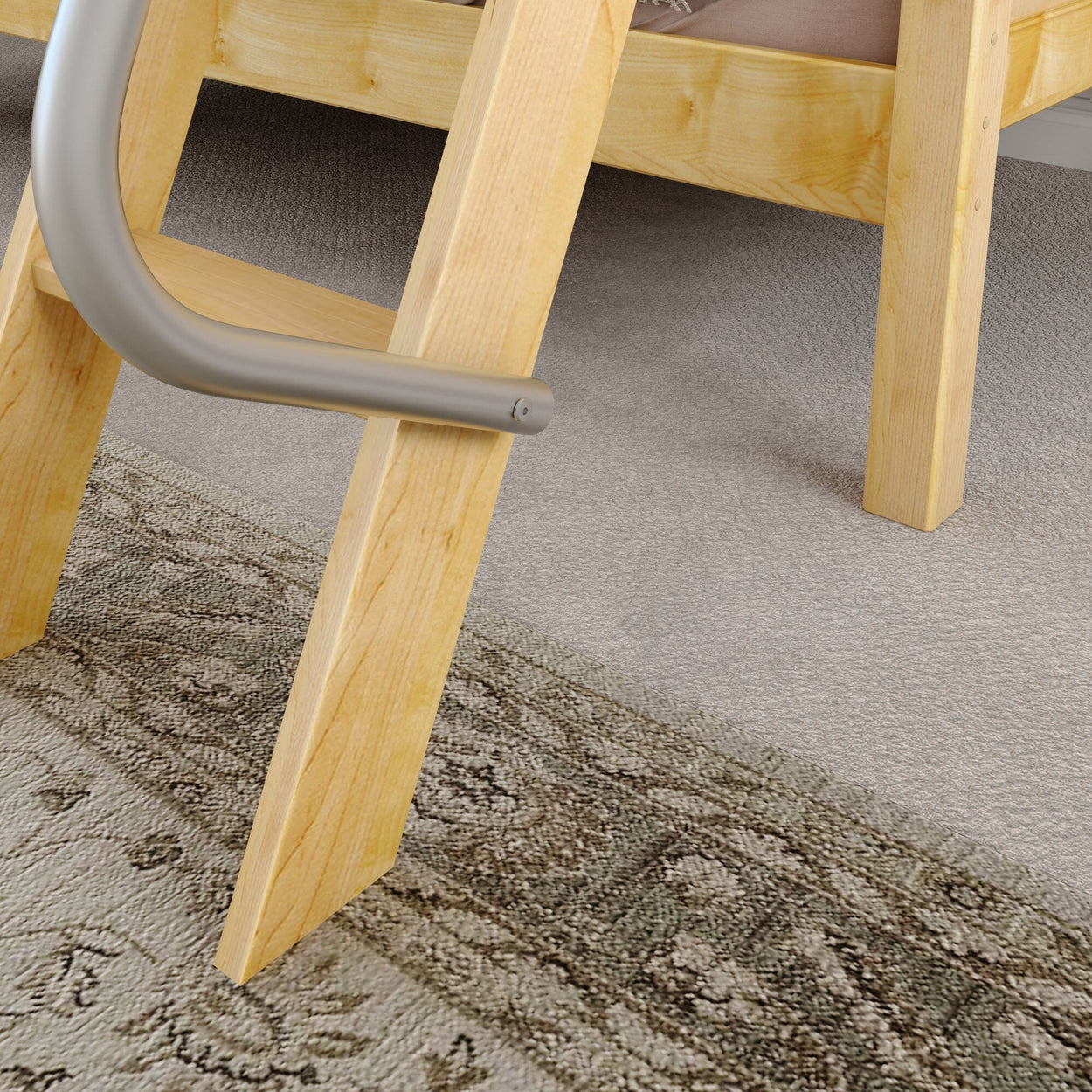 Wooden ladder attached to a wooden bed frame on a carpeted floor with decorative rug.