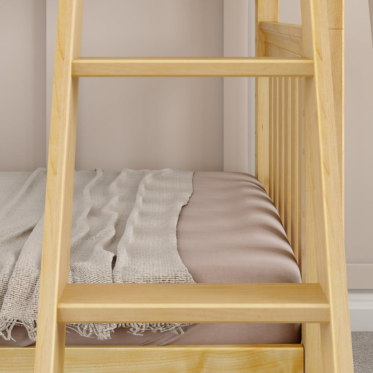 Wooden bunk bed detail with beige bedding and a cozy light gray throw blanket.