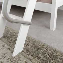 White bunk bed ladder detail with carpeted floor and patterned rug.