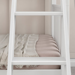 White bunk bed frame with pink mattress and beige blanket in modern bedroom.