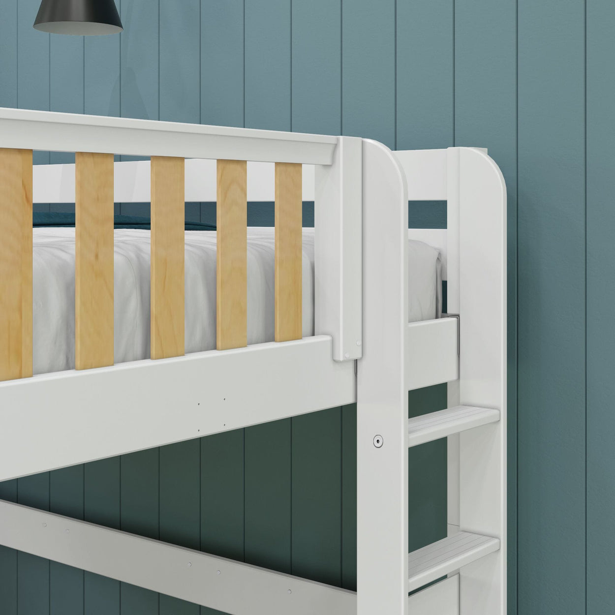 White wooden bunk bed with ladder and blue wall background.