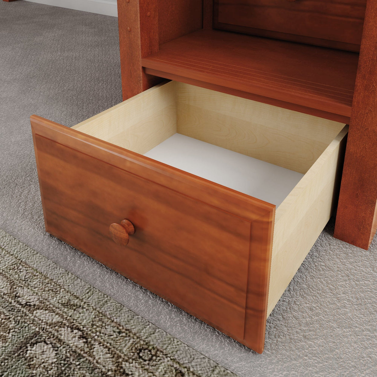 Open wooden drawer in a carpeted room, showing ample storage space.