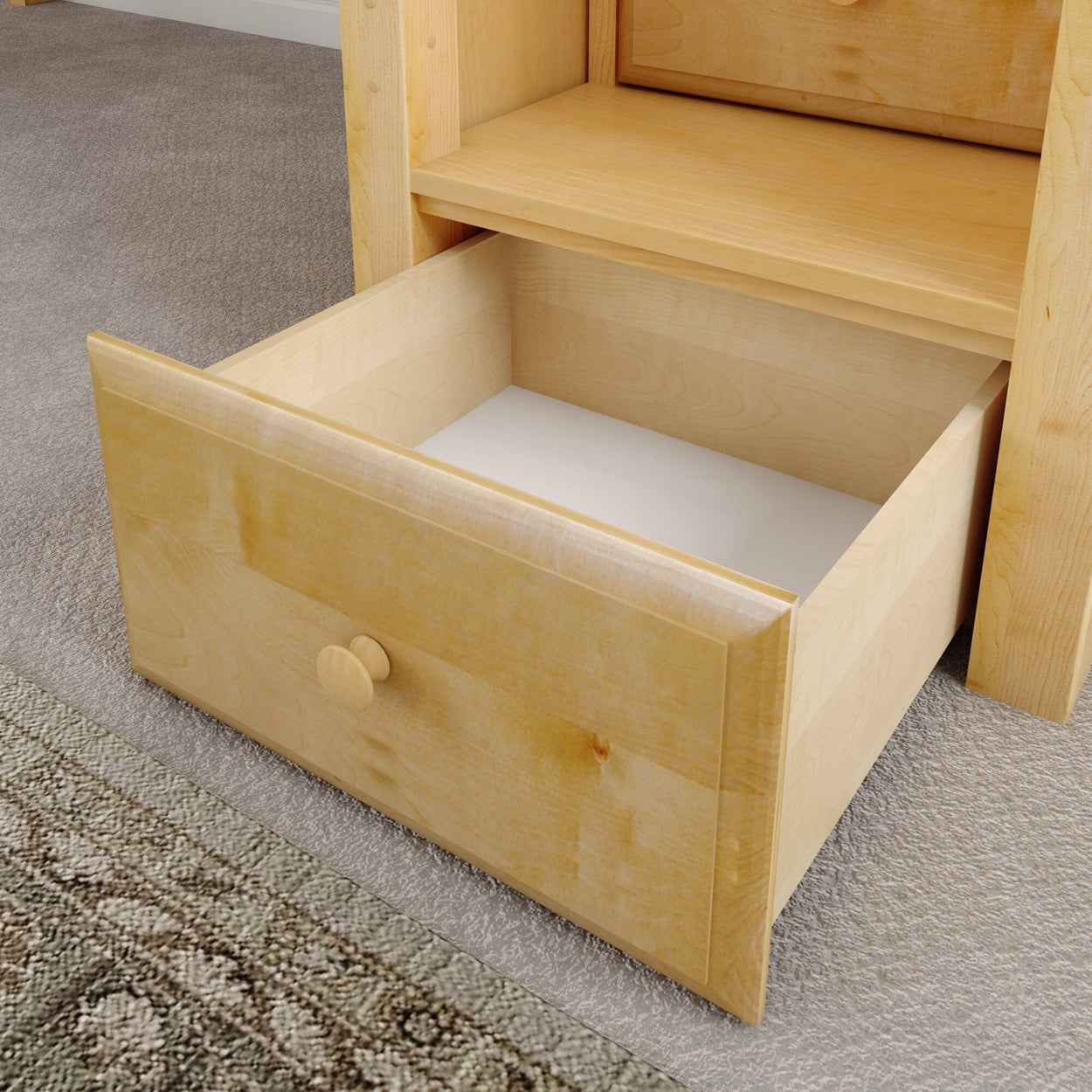 Open wooden drawer on beige carpet in modern home interior.