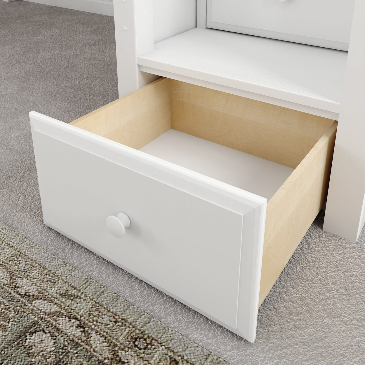 Open white wooden drawer on carpeted floor with visible interior.