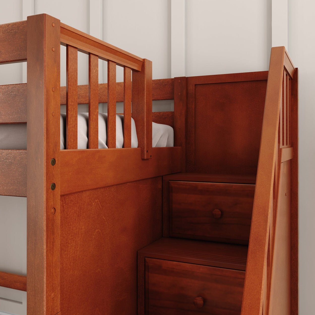 Wooden bunk bed with storage stairs against a white wall.
