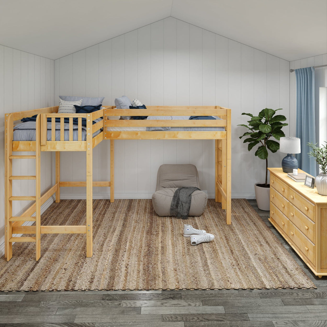 Lofted kids' bedroom with wooden bunk beds, cozy seating, dresser, and green plant.