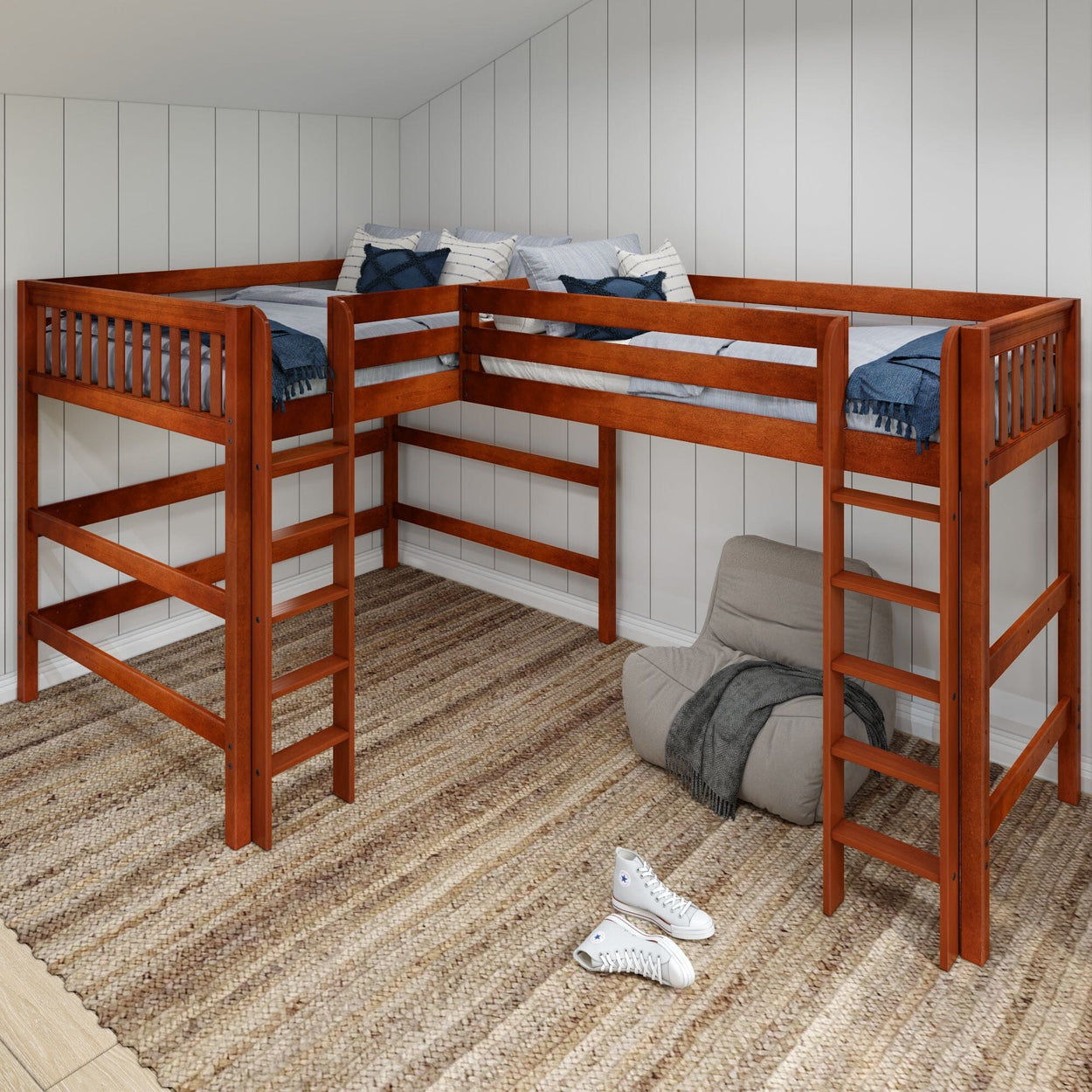L-shaped wooden loft bed with ladders in a cozy, modern bedroom setting with neutral decor.