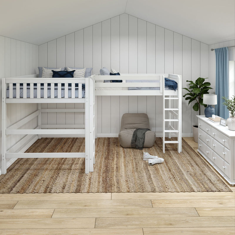 White wooden bunk bed in a bright kids' bedroom with vertical shiplap wall and vaulted ceiling, blue pillows and curtains, natural jute rug, potted plant and white dresser