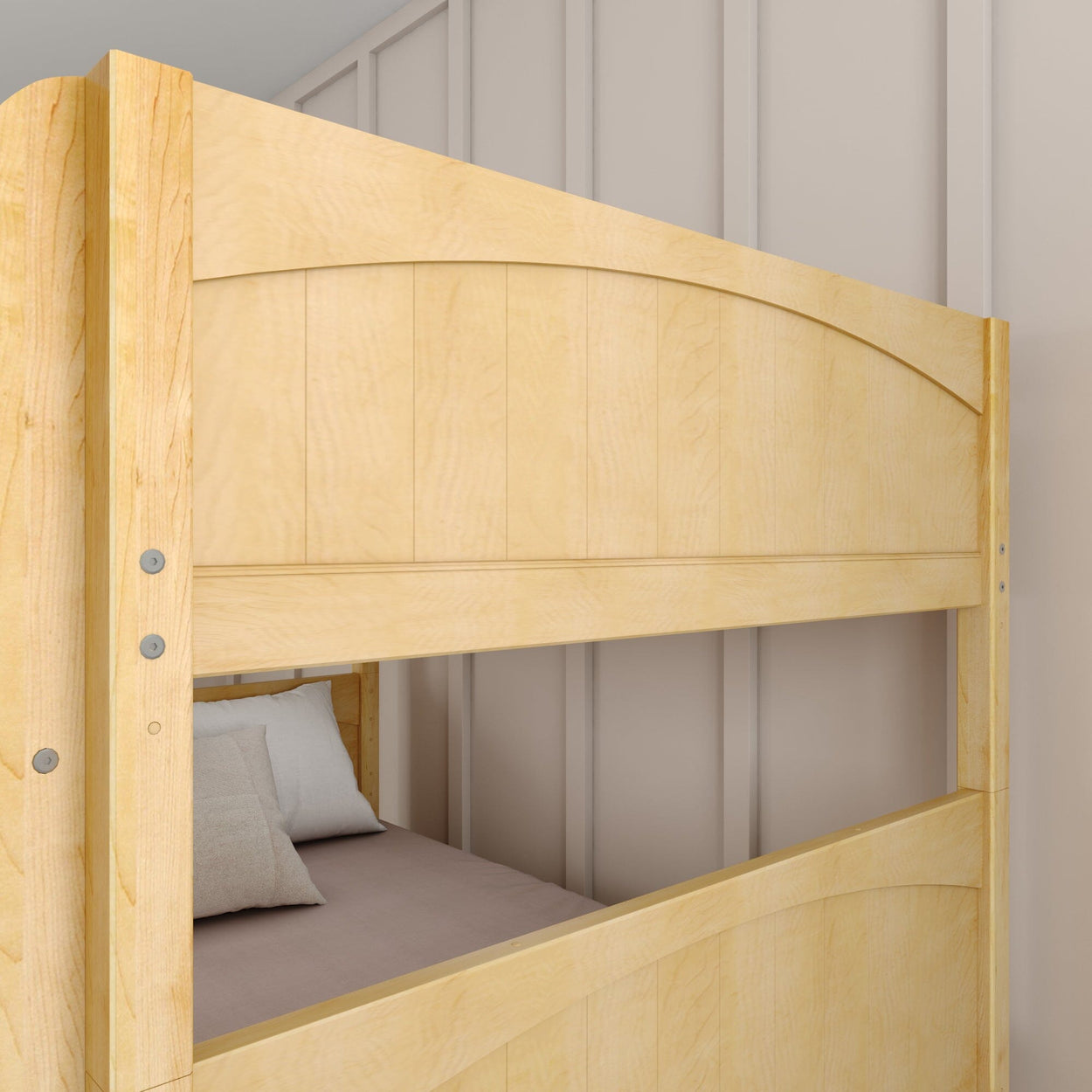 Wooden bunk bed with comfortable pillows in a modern bedroom setting.
