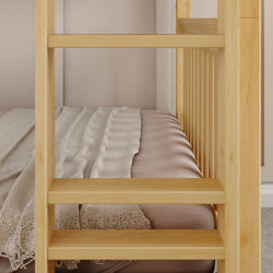 Wooden bunk bed ladder against a cozy bed with a soft beige blanket in a modern bedroom setting.