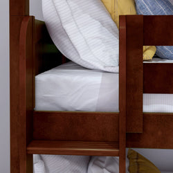 Wooden bunk bed with soft white bedding and striped pillows.