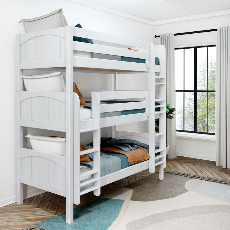 White wooden bunk bed with ladder and teal bedding in a sunlit kids' bedroom with hardwood floors, area rug, and large black-framed window
