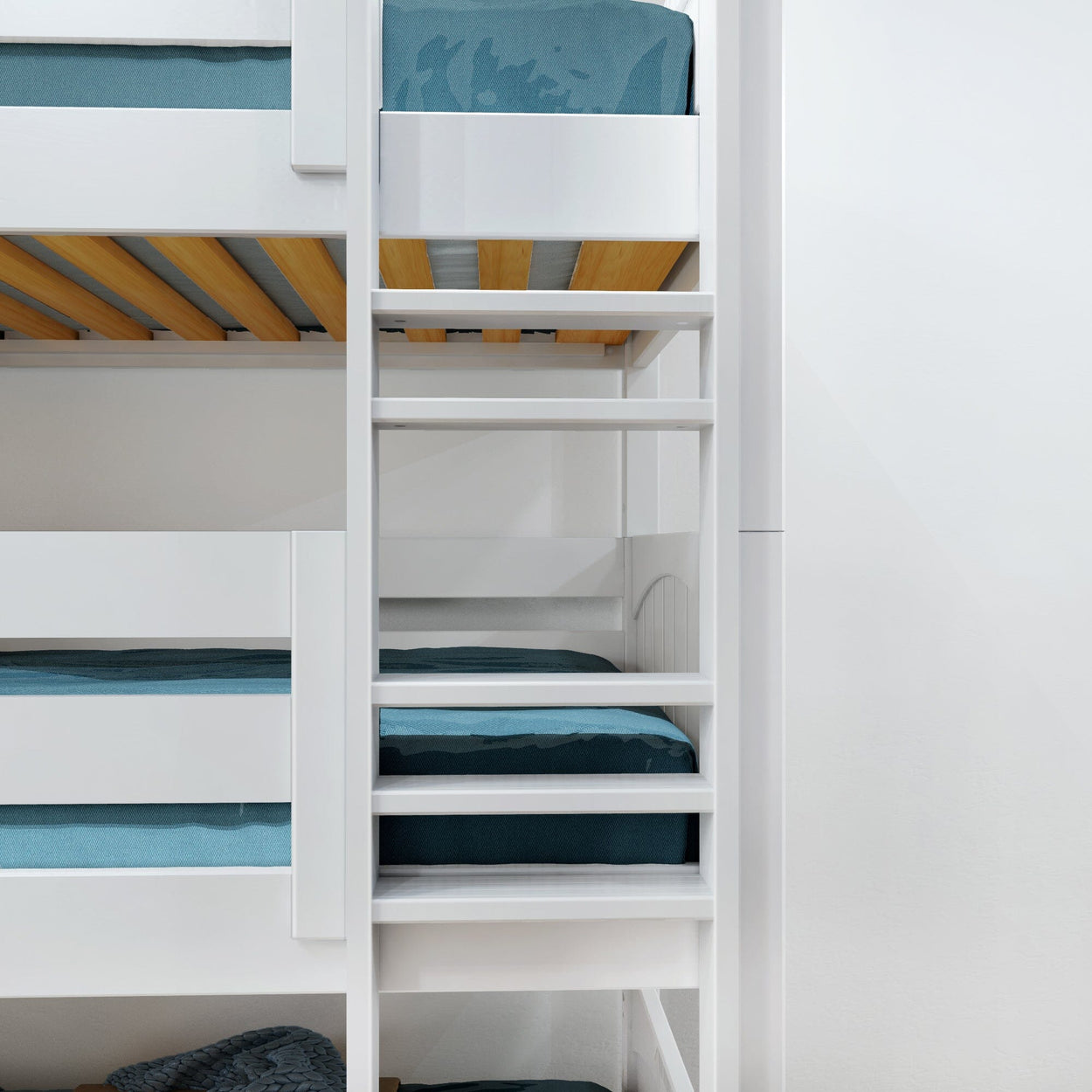 White wooden bunk bed with blue linens and ladder in modern bedroom setting.