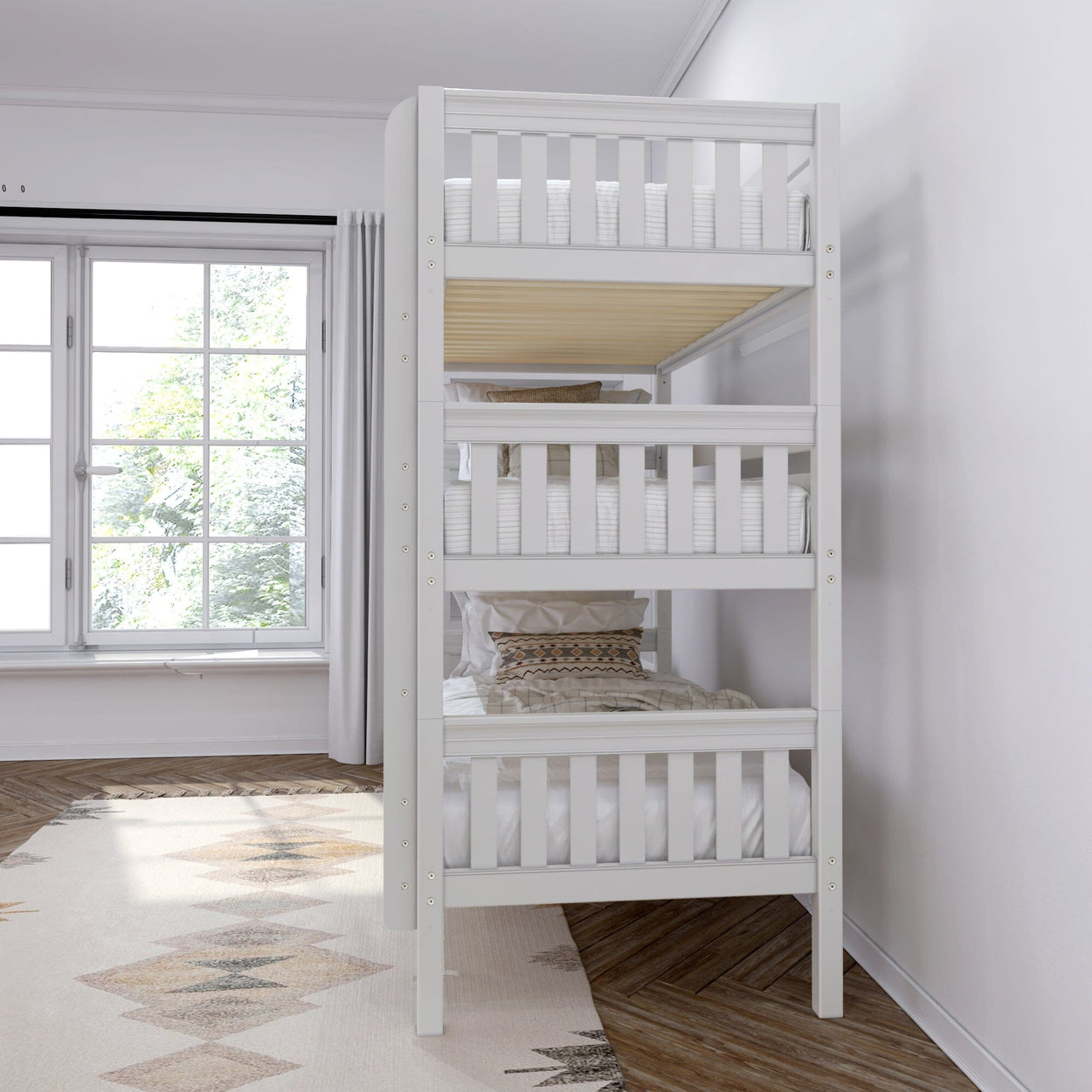 Modern white triple bunk bed in a bright bedroom with large window and geometric rug.
